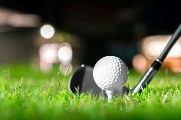 186052055 golf ball on tee in beautiful grass in golf course for shot to hole in one in competition with iron